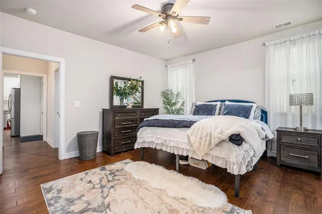 a bedroom with a large bed and a chandelier