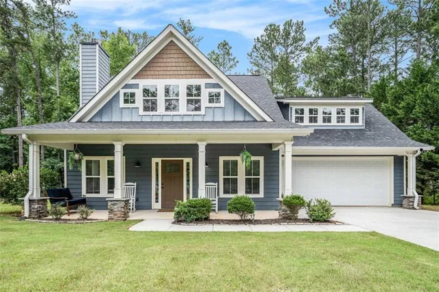 a front view of a house with swimming pool having outdoor seating