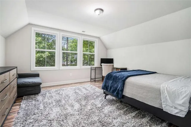 a bed room with a bed and a chair