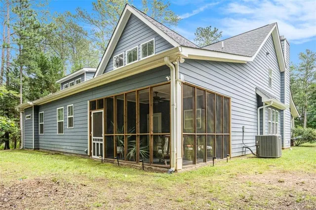 a view of a house with a large window and yard