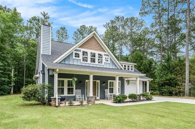 a front view of a house with a garden and porch