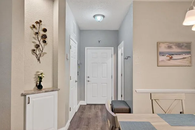 wooden floor with white walls and a potted plant