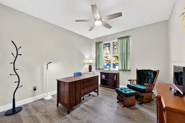 a view of a workspace with furniture and a window