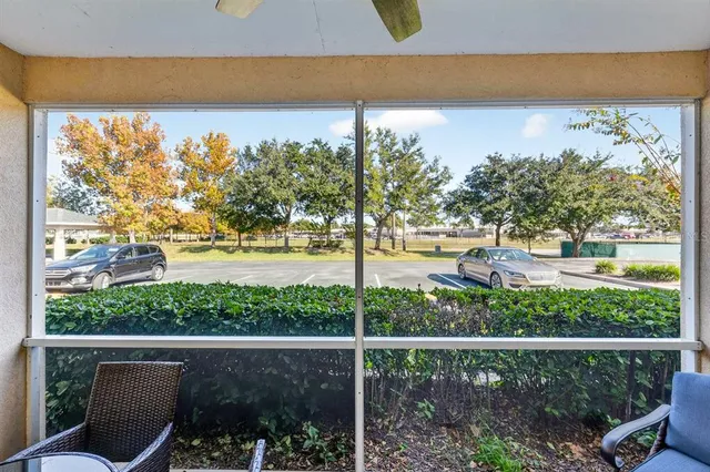 a view of a livingroom with furniture wooden floor and a ceiling fan