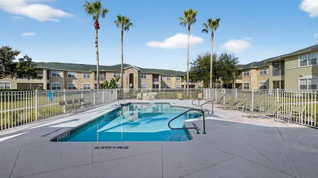 a swimming pool view with a seating space