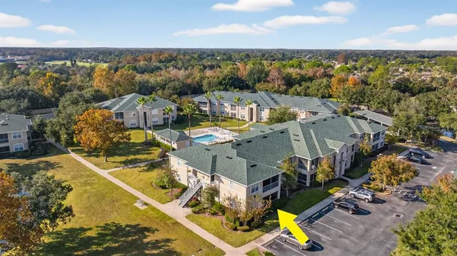 an aerial view of residential houses with outdoor space and swimming pool