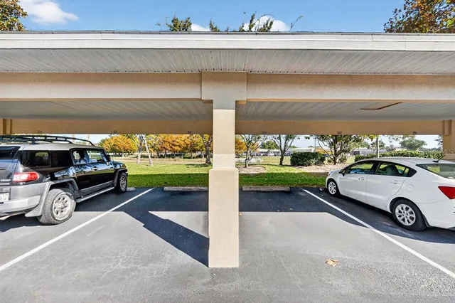 a view of a car parked in front of a house with a yard