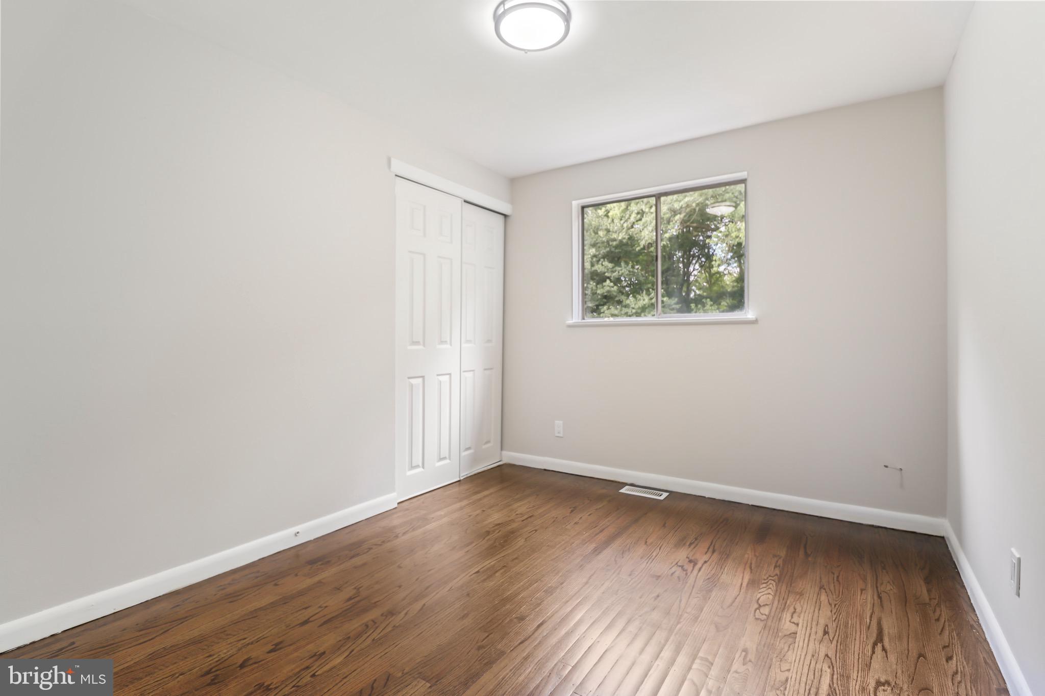 197 Pine Avenue Salem, NJ 08079 - Photo 12 of 20 an empty room with wooden floor and windows