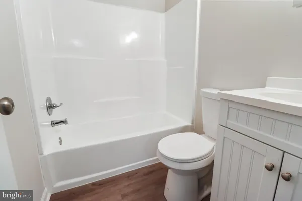 a bathroom with a toilet a sink and bathtub