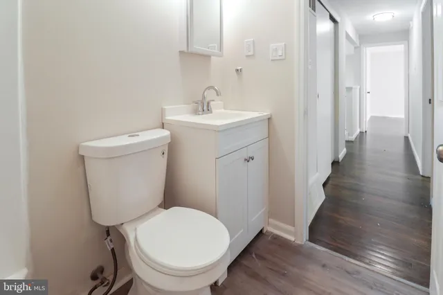 a white toilet sitting next to a bathroom sink