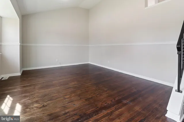 a view of a room with wooden floor