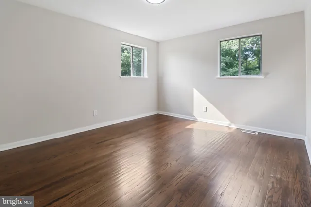 a view of a room with wooden floor and window