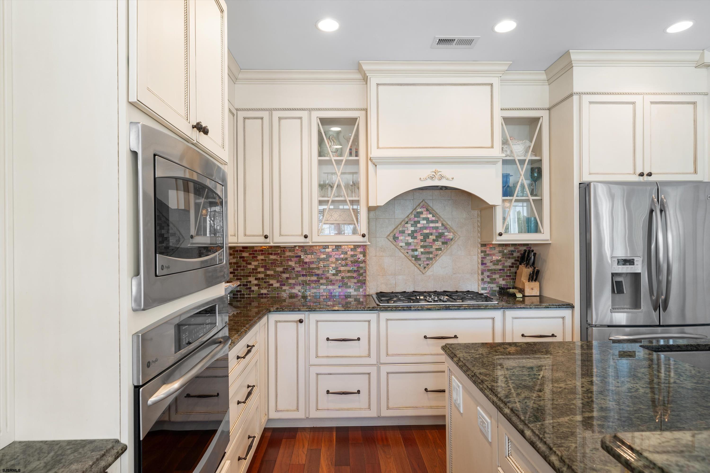 165 Pinnacle Road Ocean City, NJ 08226 - Photo 14 of 34 a kitchen with stainless steel appliances granite countertop a refrigerator a stove and a sink with wooden floor