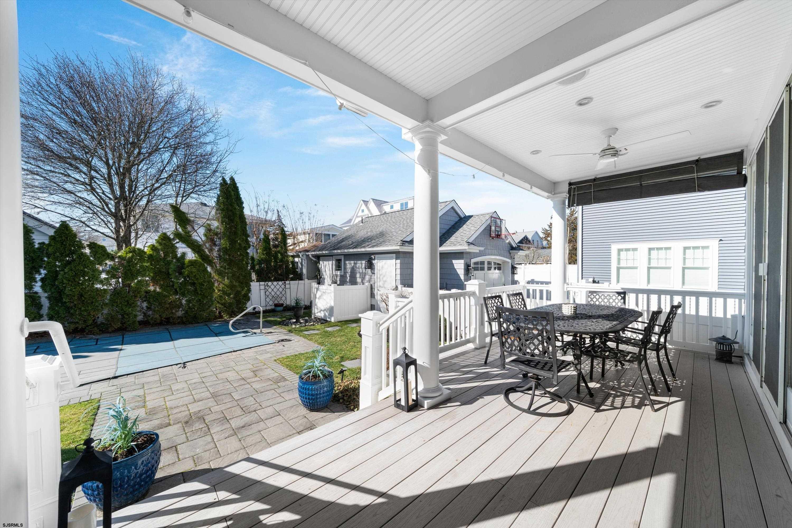 165 Pinnacle Road Ocean City, NJ 08226 - Photo 19 of 34 a view of a patio with table and chairs potted plants with wooden floor and fence