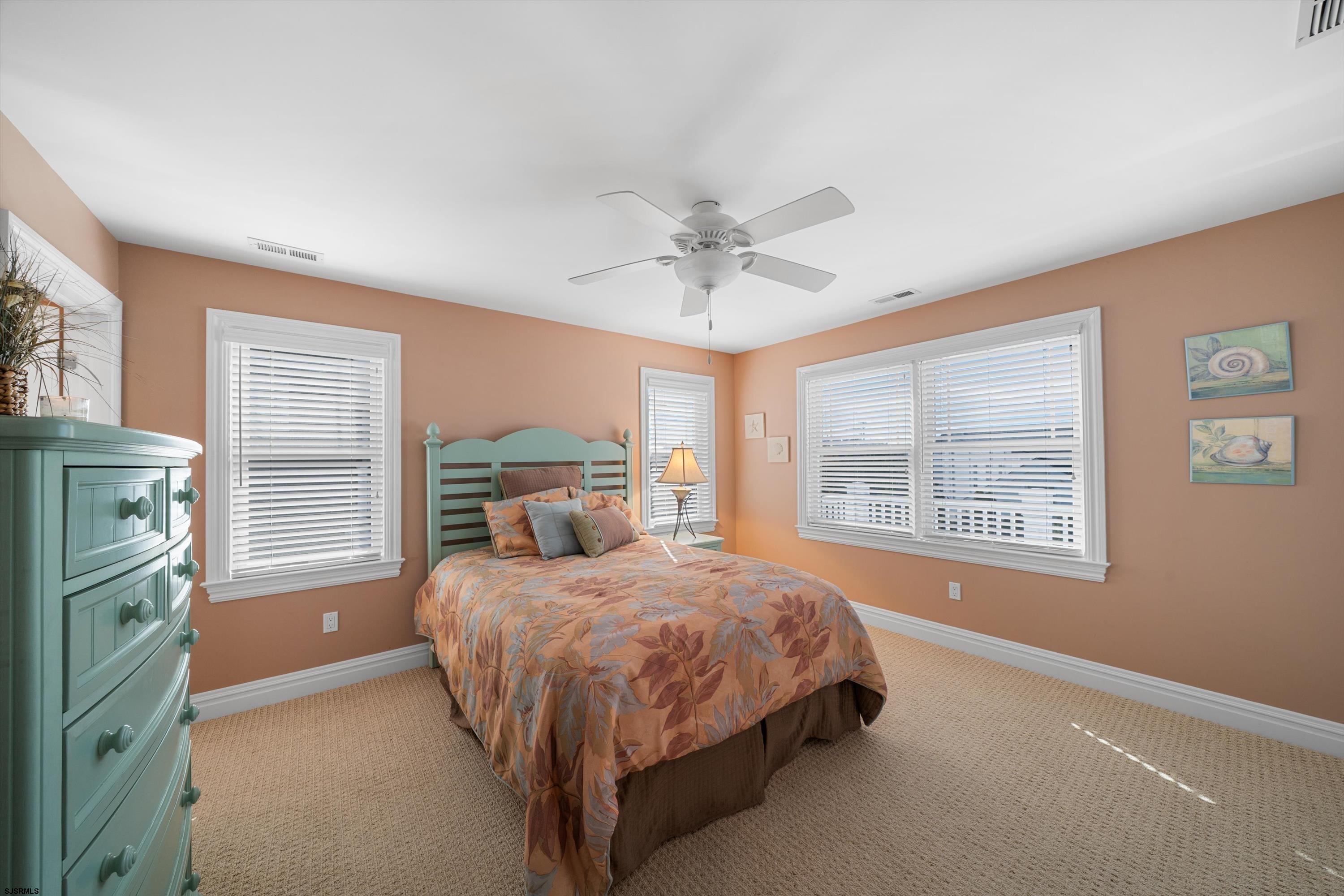 165 Pinnacle Road Ocean City, NJ 08226 - Photo 24 of 34 a bedroom with a bed next to a window with a chandelier