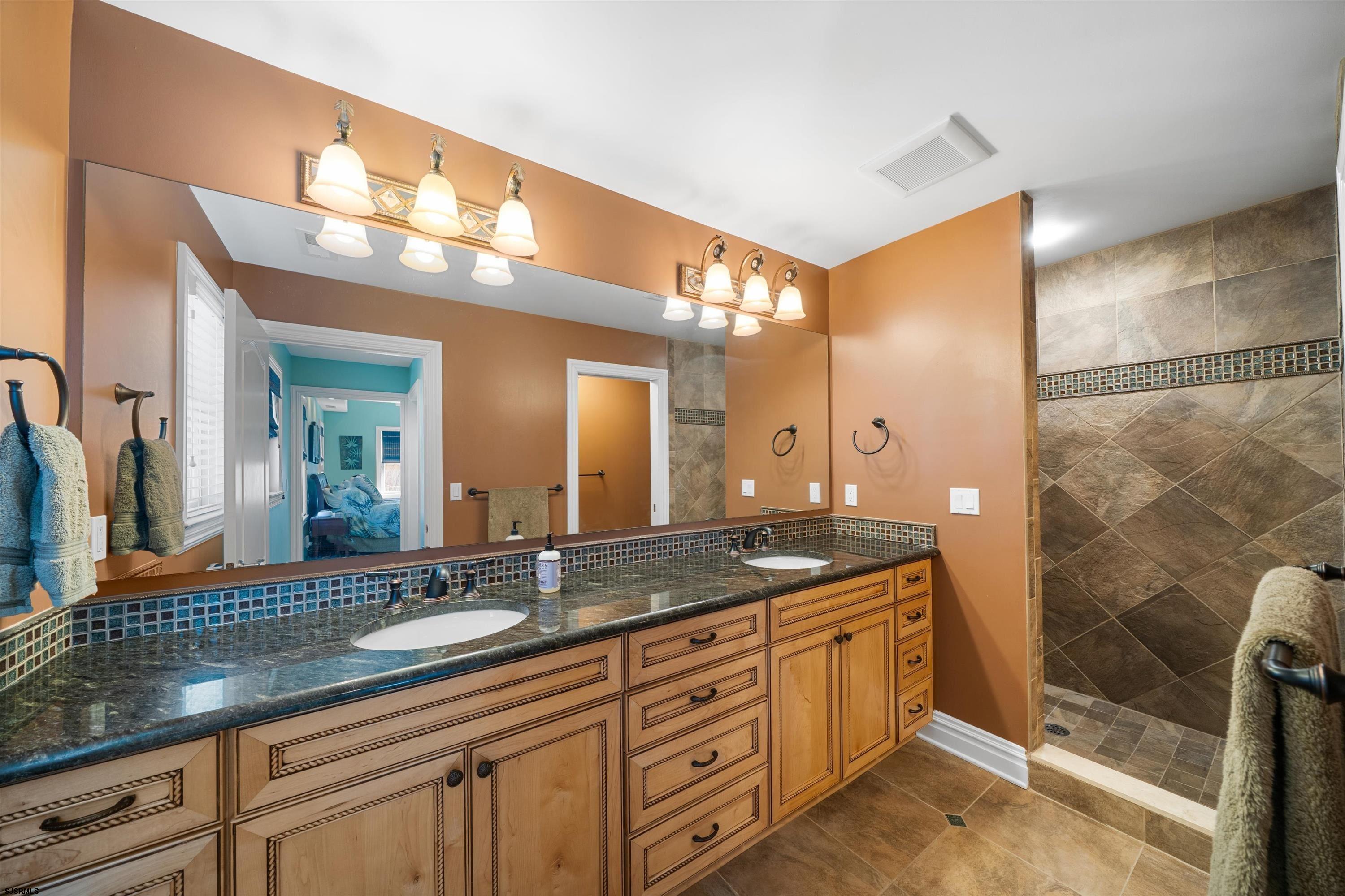 165 Pinnacle Road Ocean City, NJ 08226 - Photo 26 of 34 a bathroom with a granite countertop sink a mirror and a shower