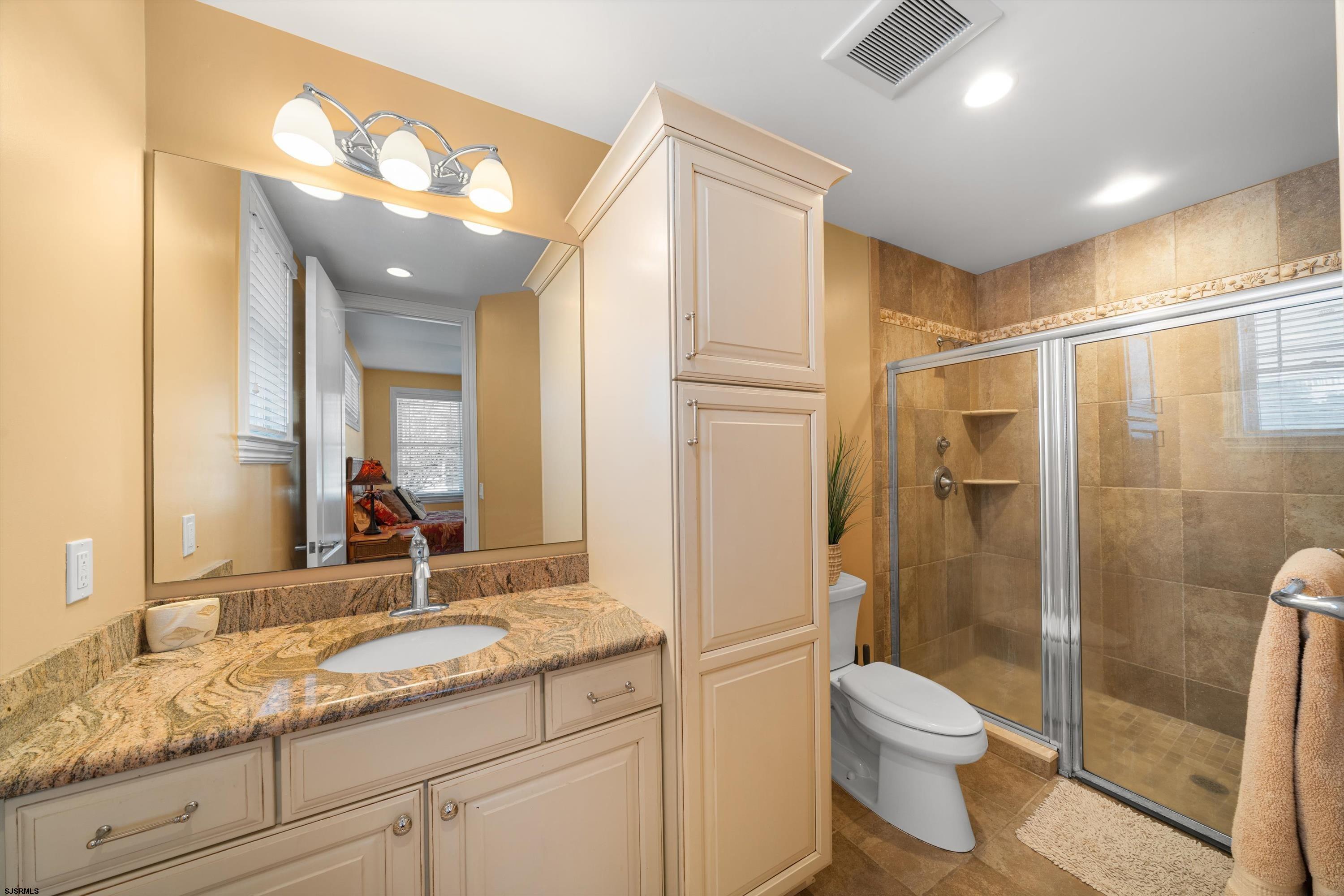 165 Pinnacle Road Ocean City, NJ 08226 - Photo 9 of 34 a bathroom with a granite countertop sink toilet and shower