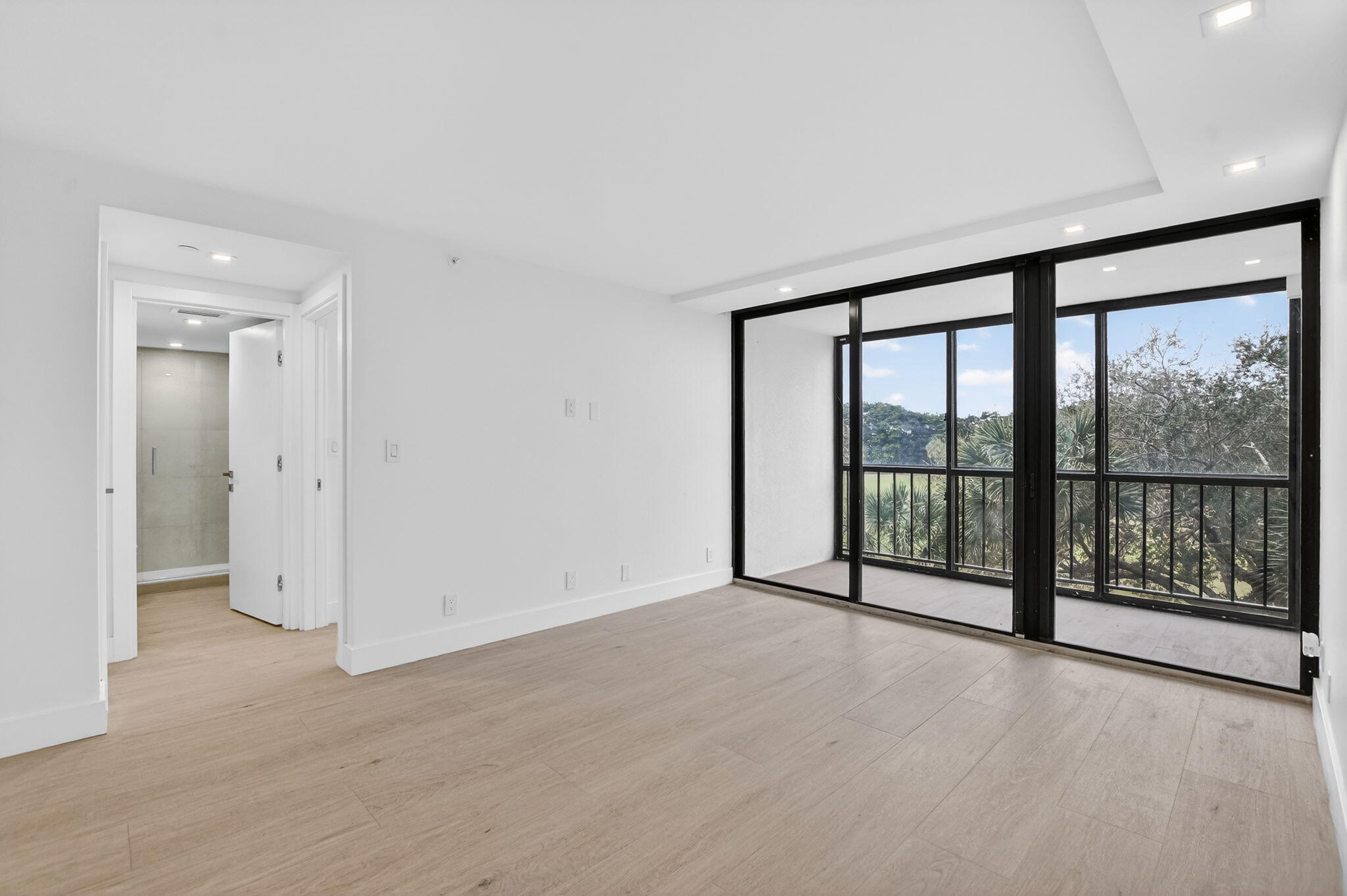 7835 Lakeside Boulevard, Unit 946 Boca Raton, FL 33434 - Photo 8 of 20 a view of an empty room with glass door