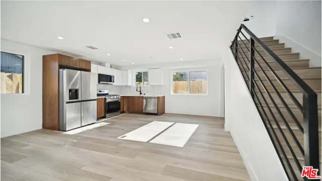 a view of a kitchen with furniture and an empty room
