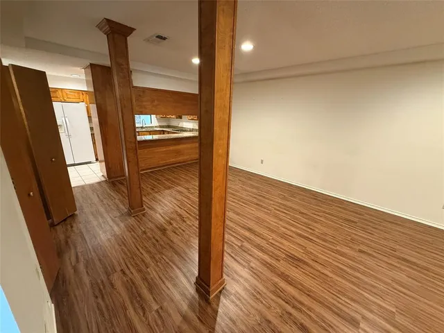 a view of a room with wooden floor