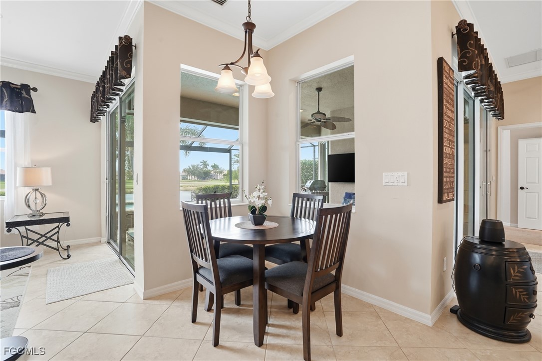 20604 Chestnut Ridge Drive North Fort Myers, FL 33917 - Photo 14 of 49 a view of a dining room with furniture and chandelier
