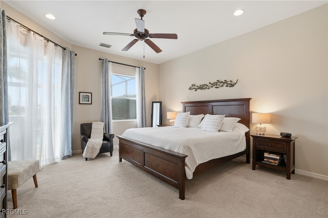 20604 Chestnut Ridge Drive North Fort Myers, FL 33917 - Photo 20 of 49 a spacious bedroom with a bed and a chandelier