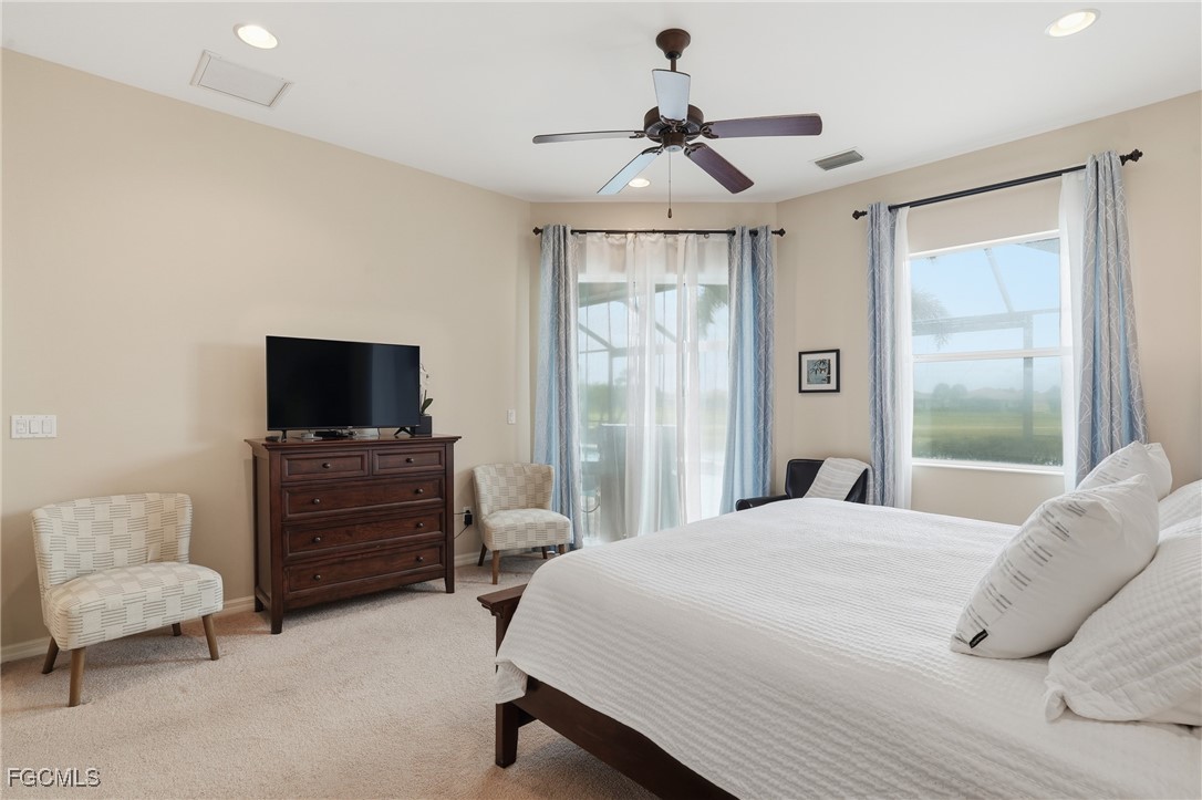 20604 Chestnut Ridge Drive North Fort Myers, FL 33917 - Photo 21 of 49 a bedroom with a bed and a flat screen tv