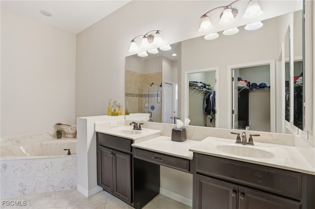 20604 Chestnut Ridge Drive North Fort Myers, FL 33917 - Photo 23 of 49 a bathroom with a sink a mirror and a bathtub