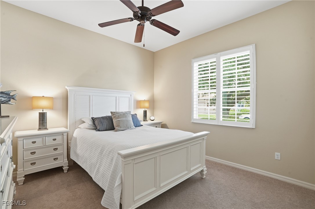 20604 Chestnut Ridge Drive North Fort Myers, FL 33917 - Photo 26 of 49 a bedroom with a bed and a chandelier
