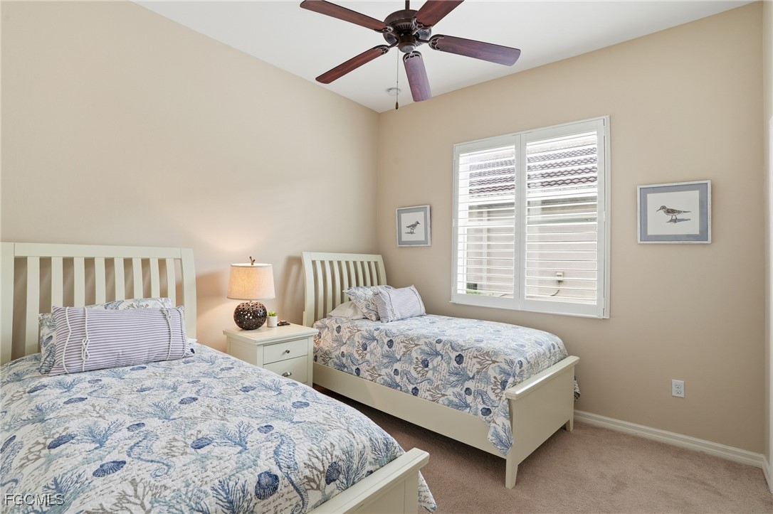 20604 Chestnut Ridge Drive North Fort Myers, FL 33917 - Photo 29 of 49 a bedroom with two beds and painting on the wall