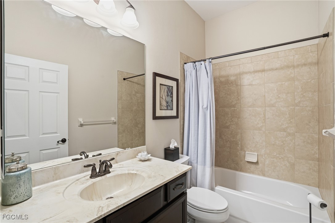 20604 Chestnut Ridge Drive North Fort Myers, FL 33917 - Photo 30 of 49 a bathroom with a sink vanity mirror and toilet