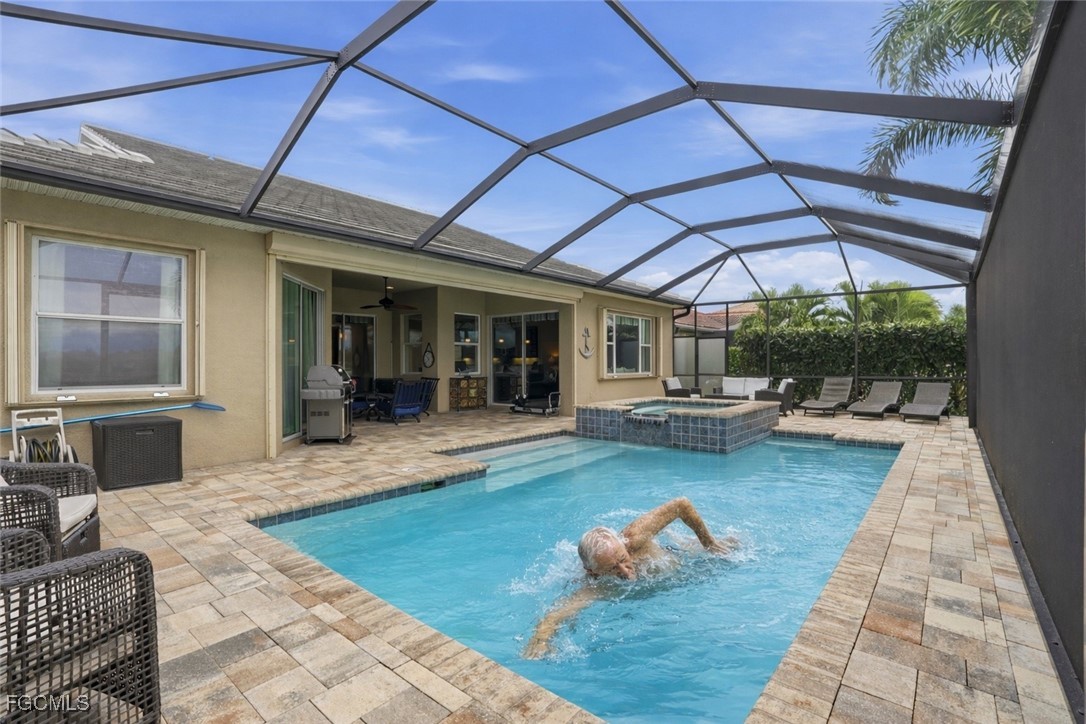 20604 Chestnut Ridge Drive North Fort Myers, FL 33917 - Photo 38 of 49 a view of a patio with table and chairs with wooden floor and plants