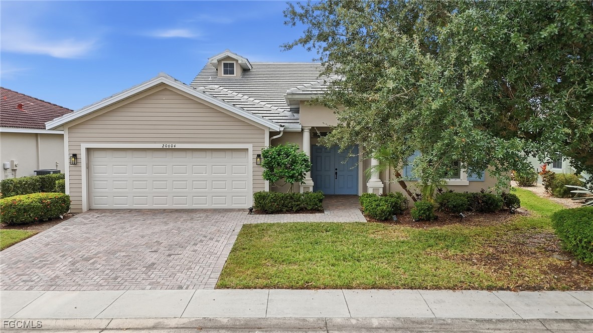20604 Chestnut Ridge Drive North Fort Myers, FL 33917 - Photo 47 of 49 a view of a house with a yard plants and large tree