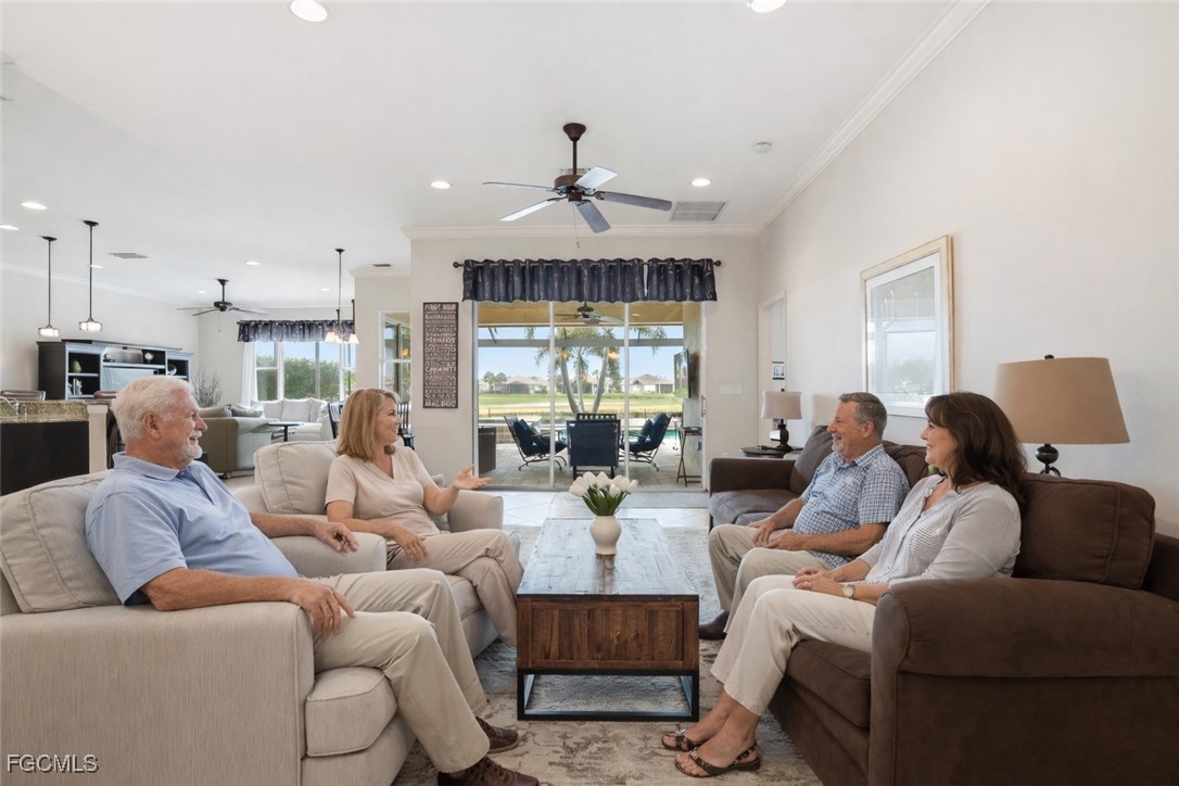 20604 Chestnut Ridge Drive North Fort Myers, FL 33917 - Photo 7 of 49 a living room with furniture a fireplace and a chandelier