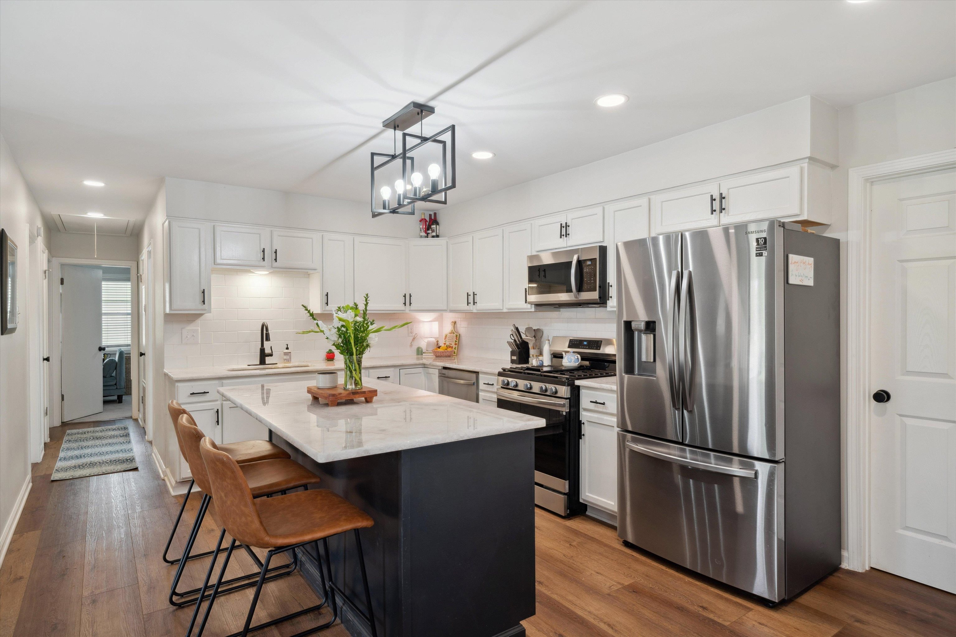 940 Greencliff Road Collierville, TN 38017 - Photo 7 of 23 a kitchen with stainless steel appliances a dining table and chairs