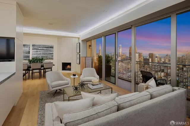 a living room with furniture and a floor to ceiling window
