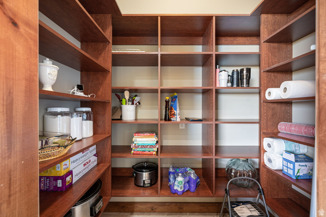 2331 West Entrada Trail, Unit 61 St. George, UT 84770 - Photo 18 of 69 Expansive walk-in pantry featuring built-in wood shelving, customizable shelf heights, and extensive storage capacity