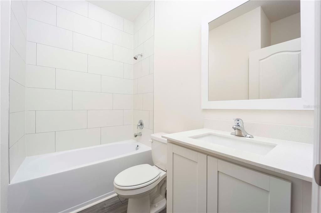 13486 Leaping Water Way Astatula, FL 34705 - Photo 17 of 20 a bathroom with a sink a toilet and a bathtub