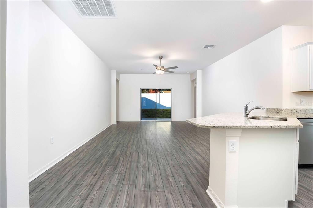 13486 Leaping Water Way Astatula, FL 34705 - Photo 5 of 20 a kitchen with a sink and wooden floor