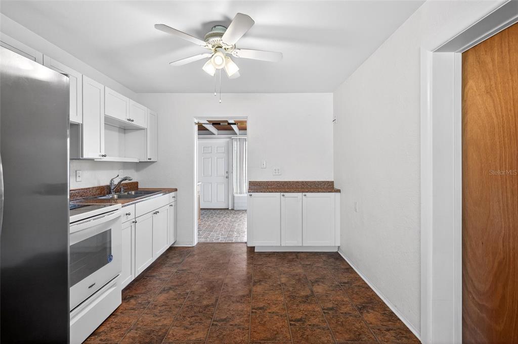 47 Carol Road Ormond Beach, FL 32176 - Photo 8 of 54 a large white kitchen with a stove a sink and dishwasher