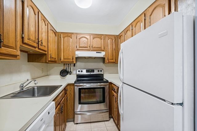 a kitchen with stainless steel appliances a stove a sink and a refrigerator