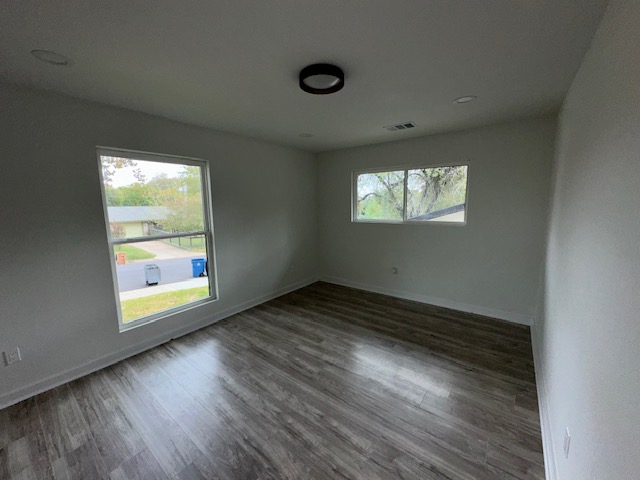 2101 Vanderbilt Lane Austin, TX 78723 - Photo 9 of 11 Spare room featuring dark wood-style flooring and baseboards