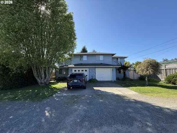 a view of a house with a yard and sitting area