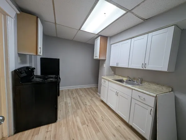 a kitchen with a sink and cabinets