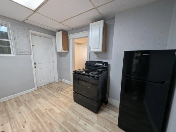 a kitchen with a refrigerator stove and cabinets