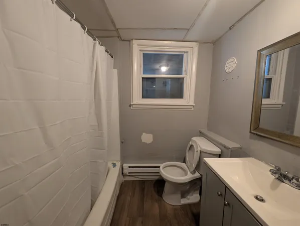 a bathroom with a toilet sink and shower