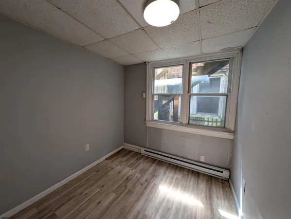 a view of wooden floor and windows in a room