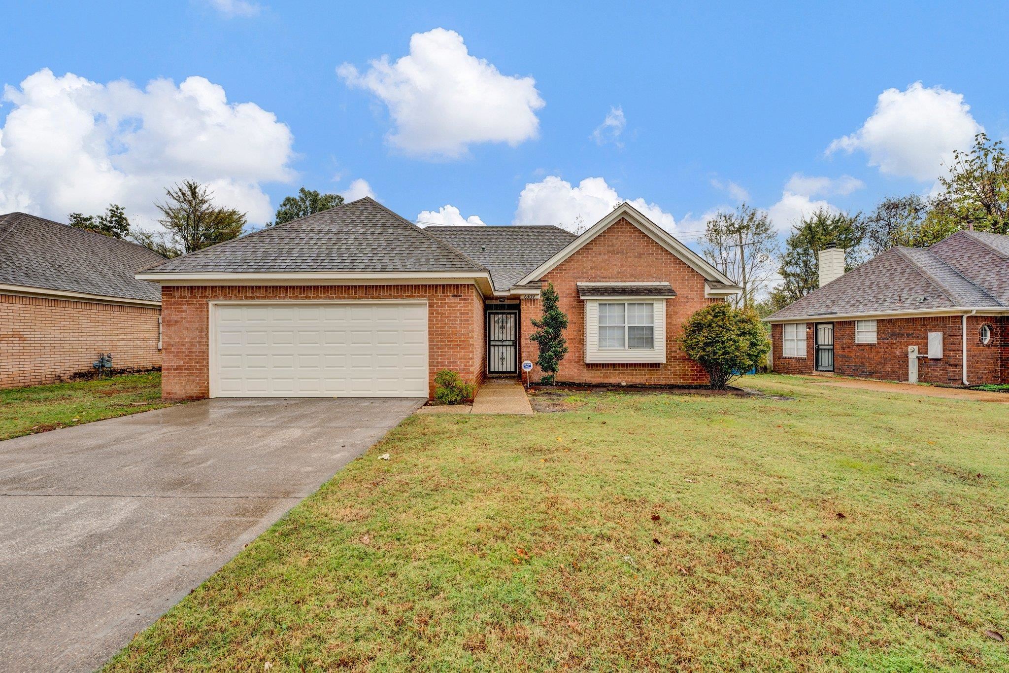 6309 Ragan Farm Drive Memphis, TN 38141 - Photo 1 of 25 Ranch-style house featuring a garage and a front lawn