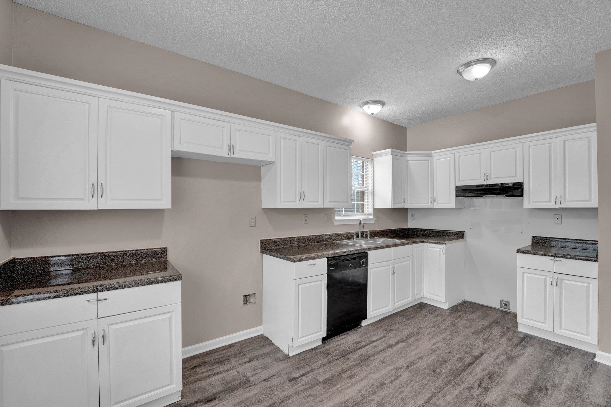6309 Ragan Farm Drive Memphis, TN 38141 - Photo 12 of 25 Kitchen with white cabinets, light hardwood / wood-style floors, sink, and dishwasher