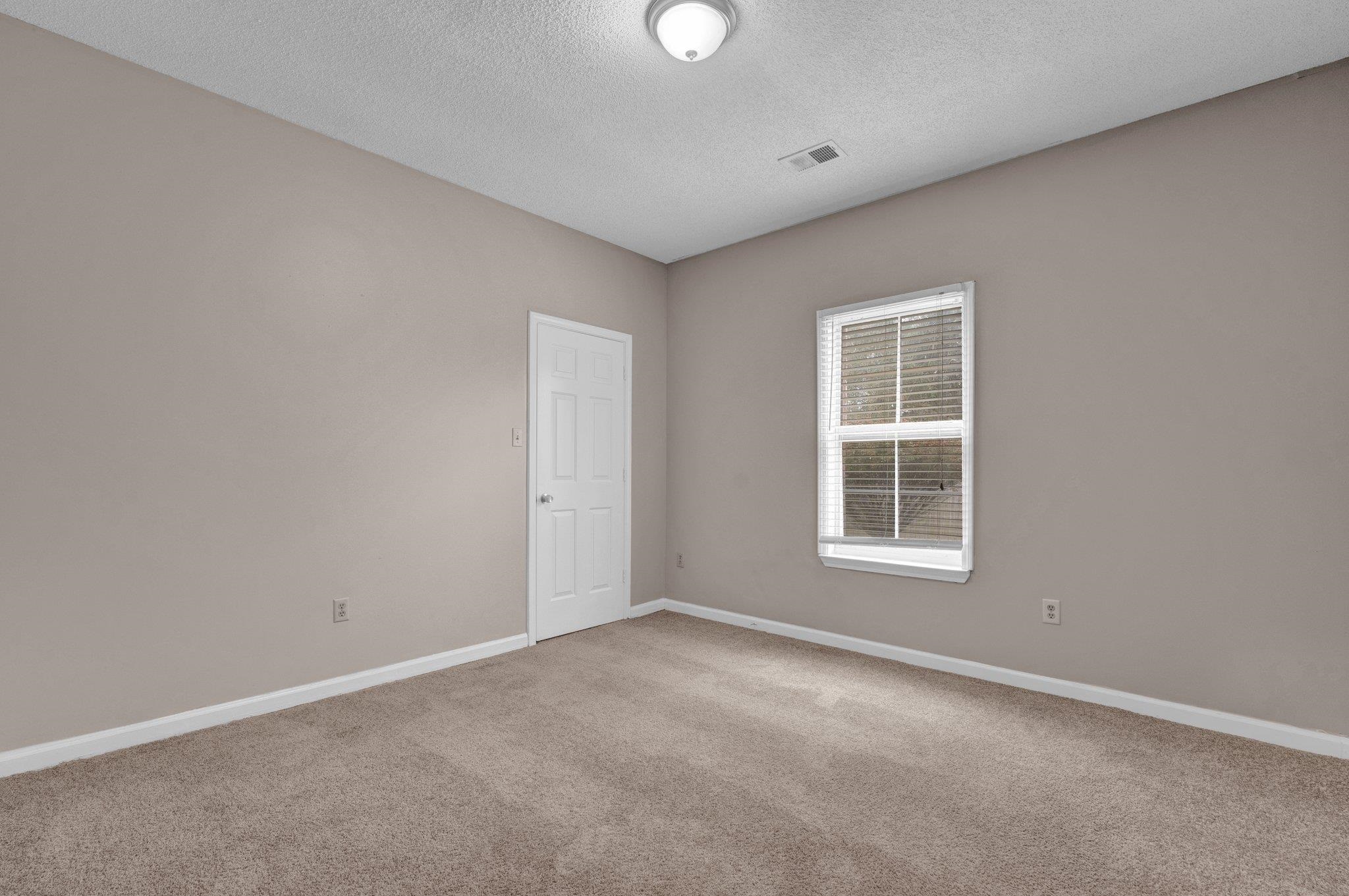 6309 Ragan Farm Drive Memphis, TN 38141 - Photo 17 of 25 Empty room with carpet and a textured ceiling